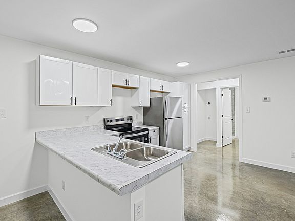Renovated kitchen area featuring new cabinetry and a spacious layout