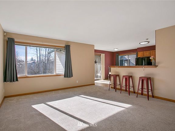 Upon entry, you are greeted by a large living area with an open concept to kitchen, dining and patio.