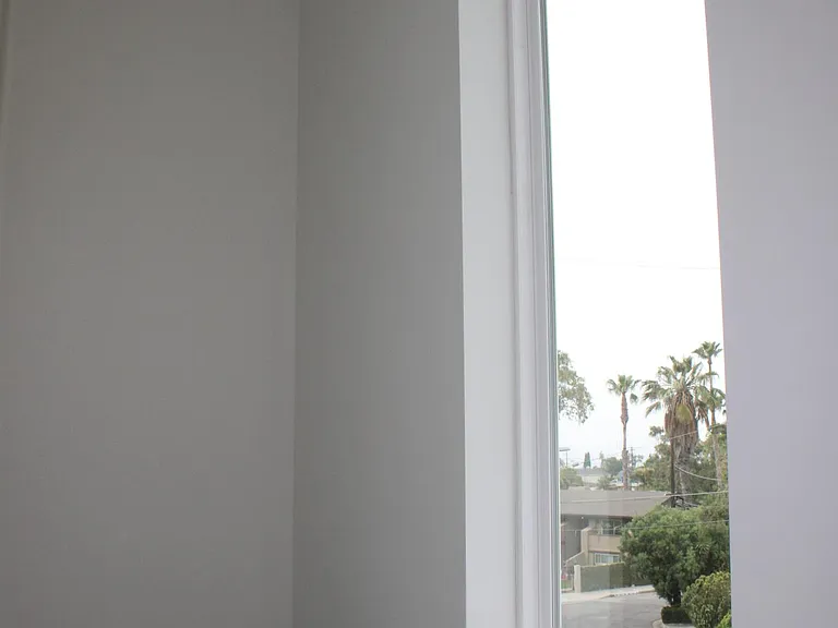 top step of second floor leading down a beautiful big window