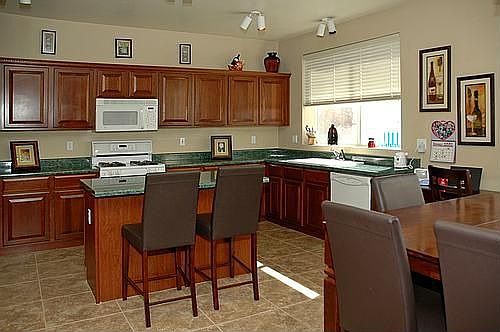 Kitchen has cherry cabinets with crown molding