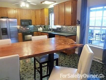 Eat-in Kitchen
						:
						42" cabinets, Walnut tree brkfast bar, mosaic tile backsplash, s/s fridge/dishw.