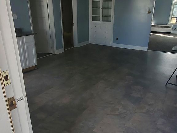 Large dining area - kitchen with stove and refrigerator to the right.