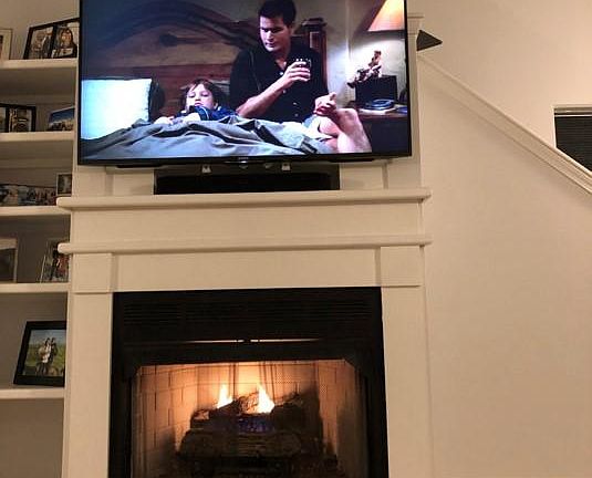 Working gas fireplace with built in shelves and wall mount tv