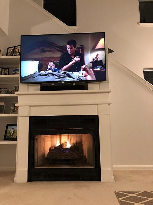 Working gas fireplace with built in shelves and wall mount tv