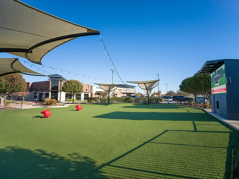 Shaded greenspace at nearby Shops at Willow Park feature open turf and seating offering a relaxed place to spend time outdoors close to home.