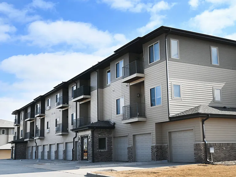 Apartment building with balconies and garages.