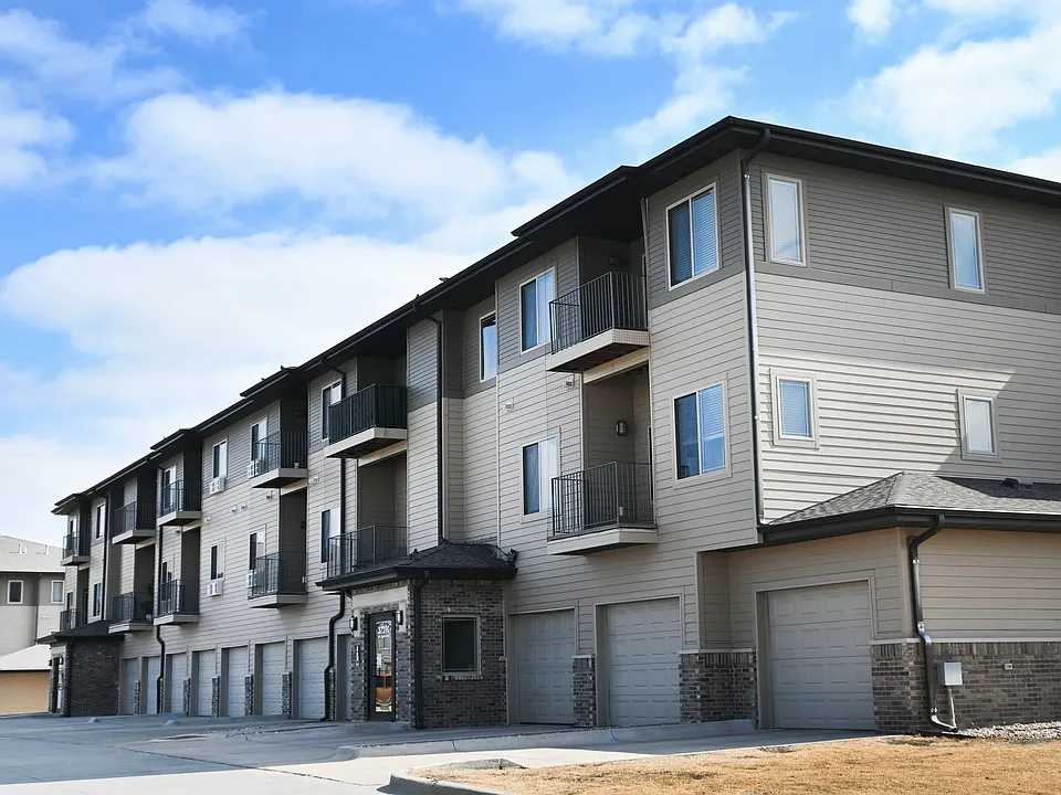 Apartment building with balconies and garages.
