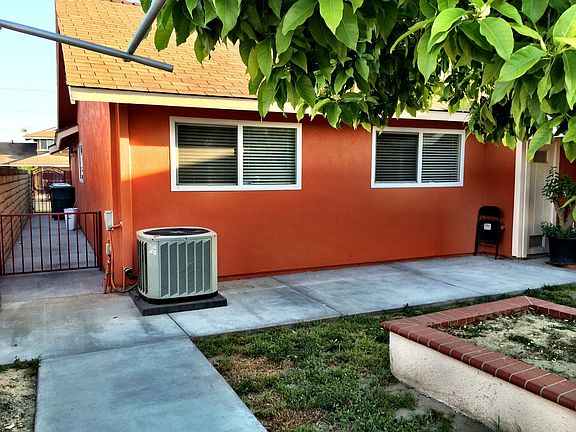 Backyard Side of House View with New Air Conditioning Unit