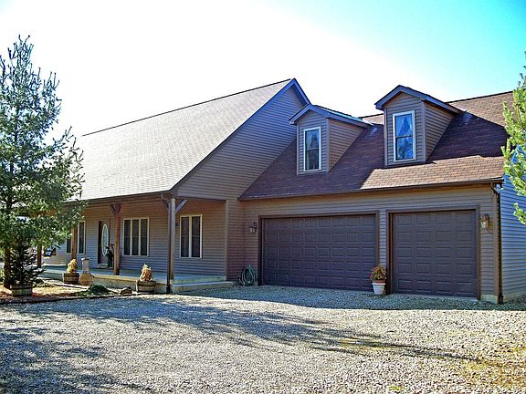 3 car side load garage. Also has a large outbuilding