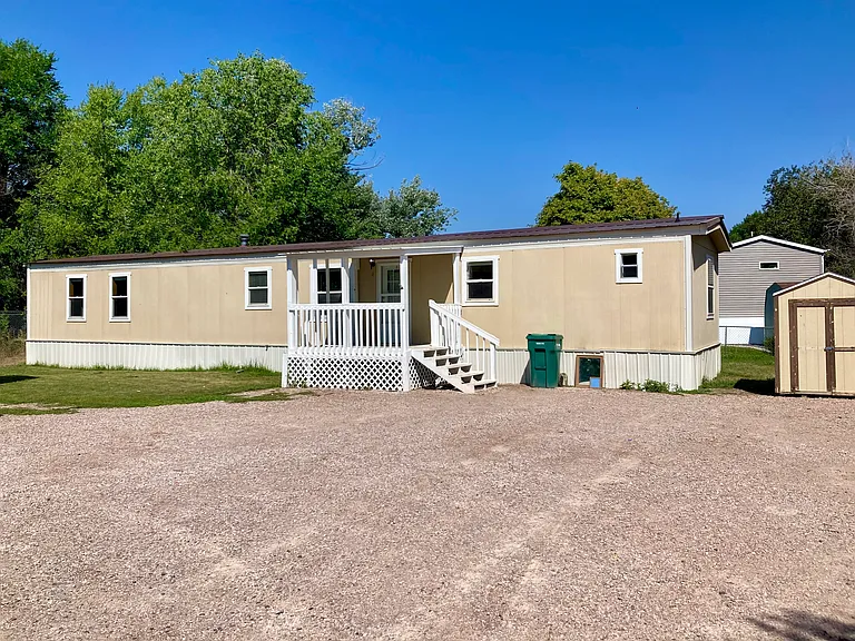 large open driveway and shed next to home