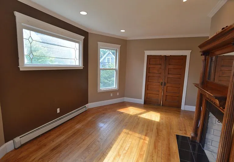 Living room connected to dining room connected via pocket wooden doors