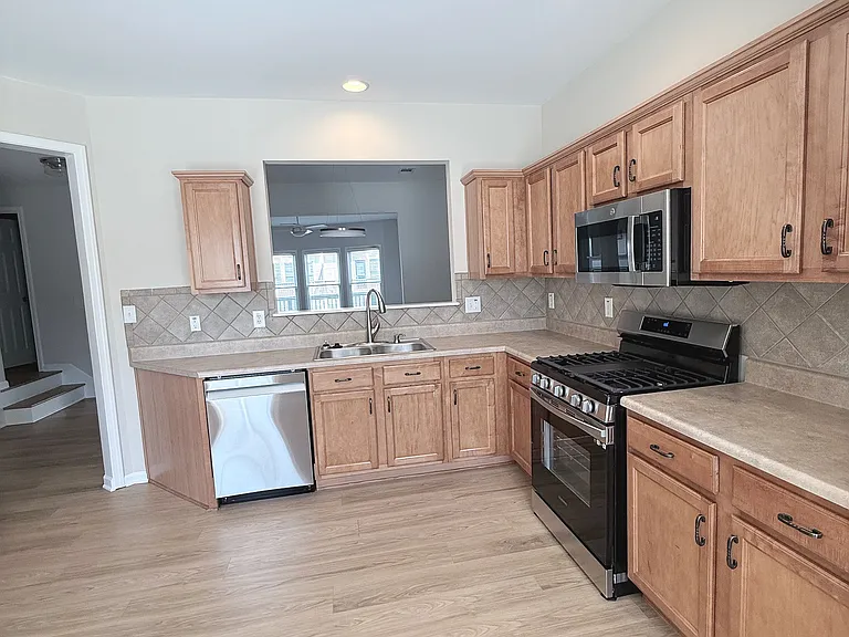 Kitchen has great natural light at looks out onto the shared green space.