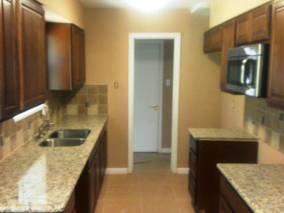 Nice remodeled kitchen with Granite counters , new cabinets, microwave, sink, tiled floors