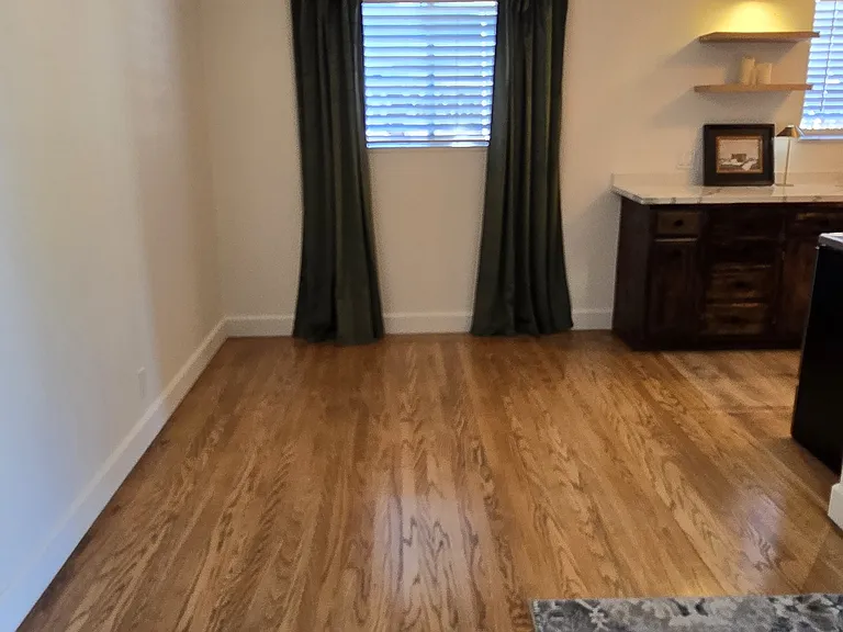 Dining room with dimmer lights. Real hardwood floors throughout.