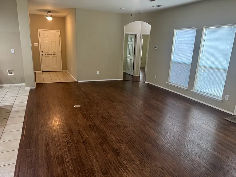 view toward the front door and opening to two bedrooms and a bath