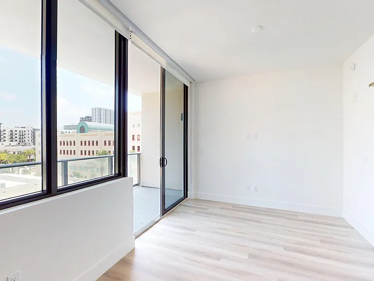 Apartment Living Room with large windows, wood-style flooring and Patio/Balcony.