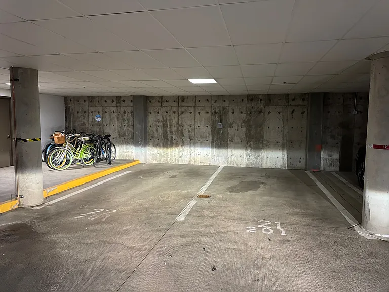 Two parking spots in the garage next to the stairway.