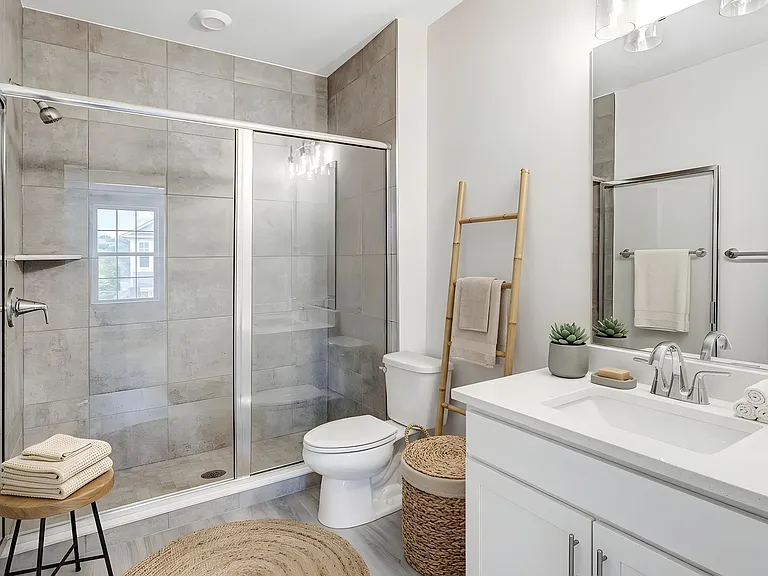 Well-appointed primary bathroom with modern finishes and a spacious vanity. Virtually staged.