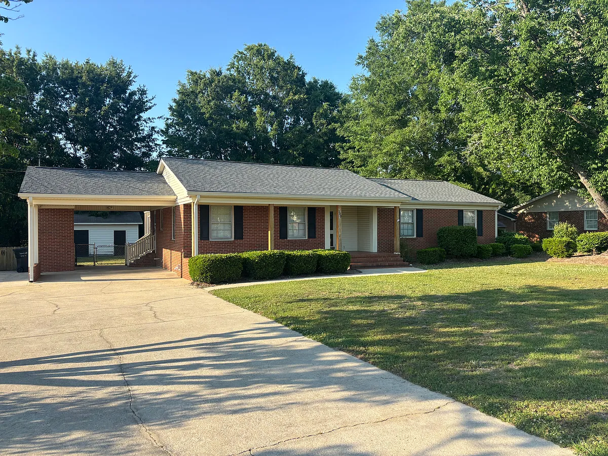 Frontside of home. Concrete driveway, carport - 102 E C St