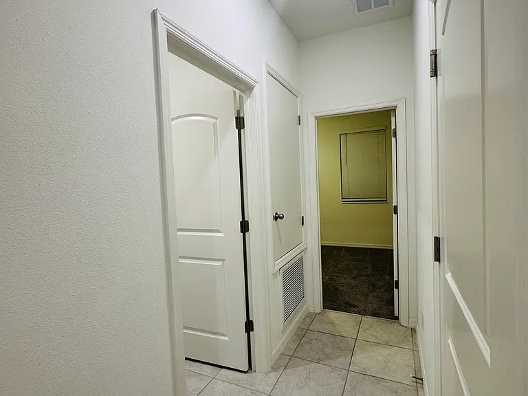 Hallway leading to laundry room and bedroom 4