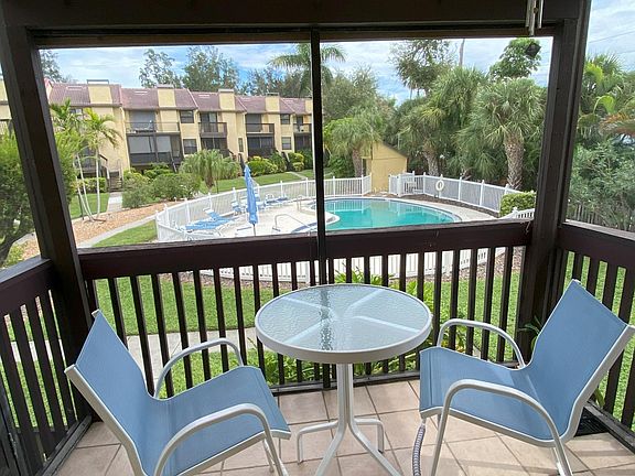 Lanai off living room area. Overlooks the common area pool.