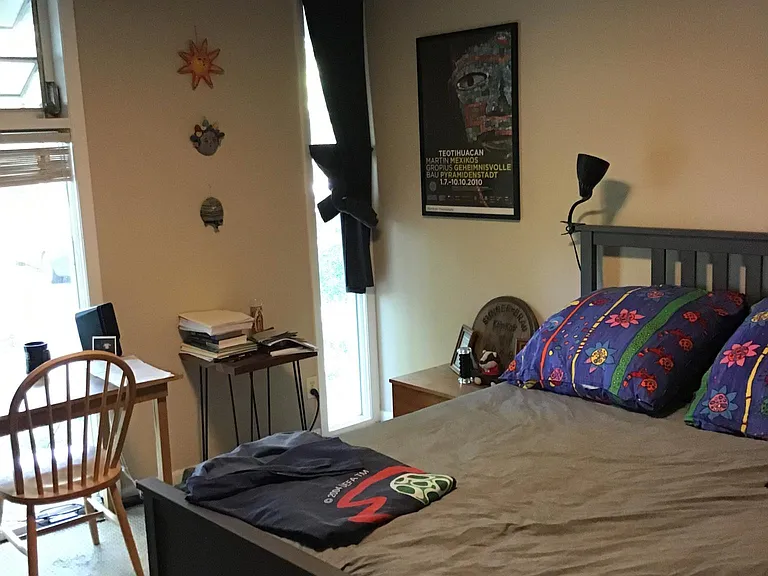 View of Front Bedroom with windows opening to front yard and in the background you can see private off-street parking.