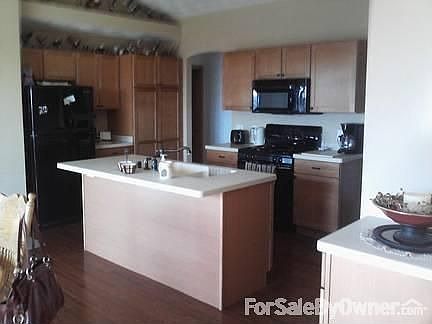 kitchen : maple floors and cupboards with solid surface counters. Vaulted ceiling