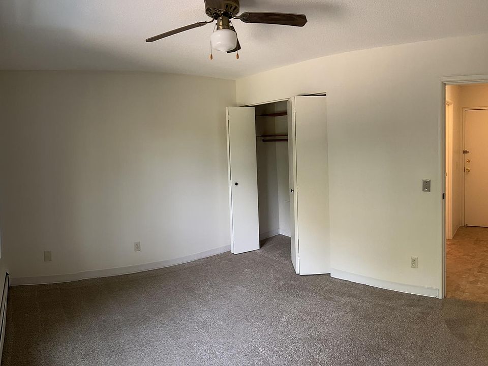 The bedroom has an oversized window, linen closet, and ceiling fan.