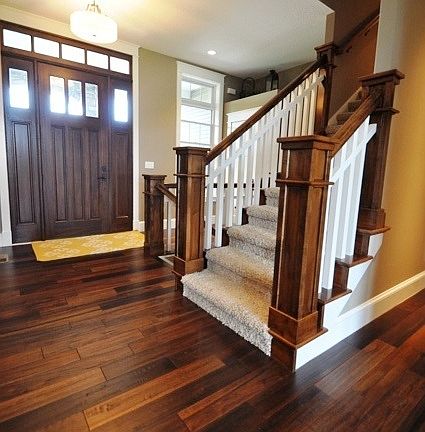 Foyer with hardwood entryway and stairs leading up to large bonus room.
