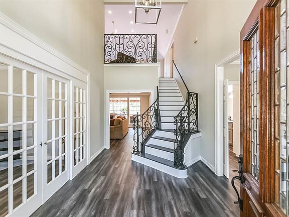 Light and bright two story foyer with updated chandelier greet you upon entry