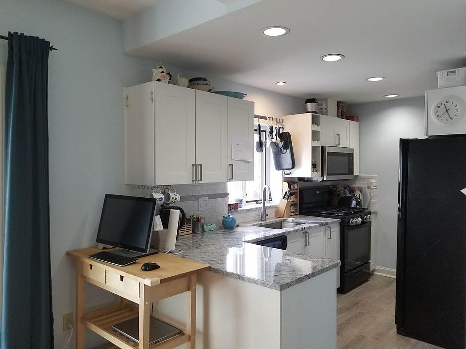 Renovated kitchen with granite counters, D/W and microwave.