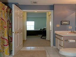 The guest bathroom features tile floors, new rainmaker shower head and combination tub/shower.