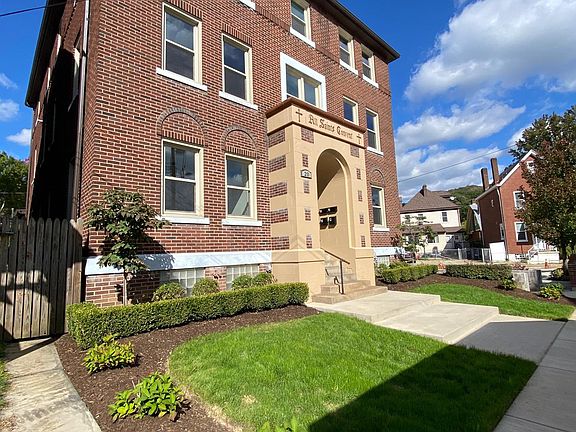 Beautiful new concrete walkway and stairs with fresh exterior paint and landscape.
