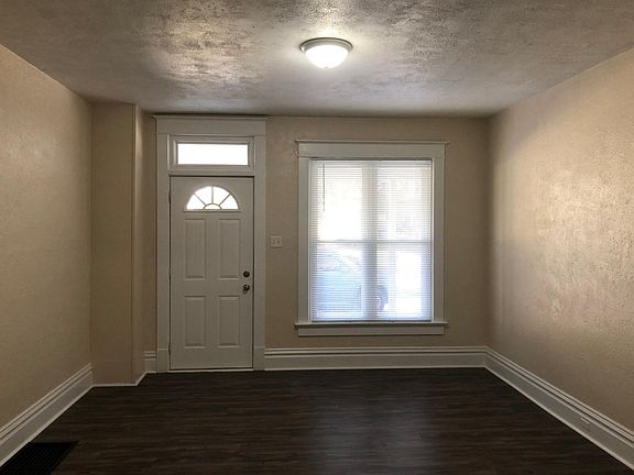 Living room and front door leading out to a beautiful covered patio