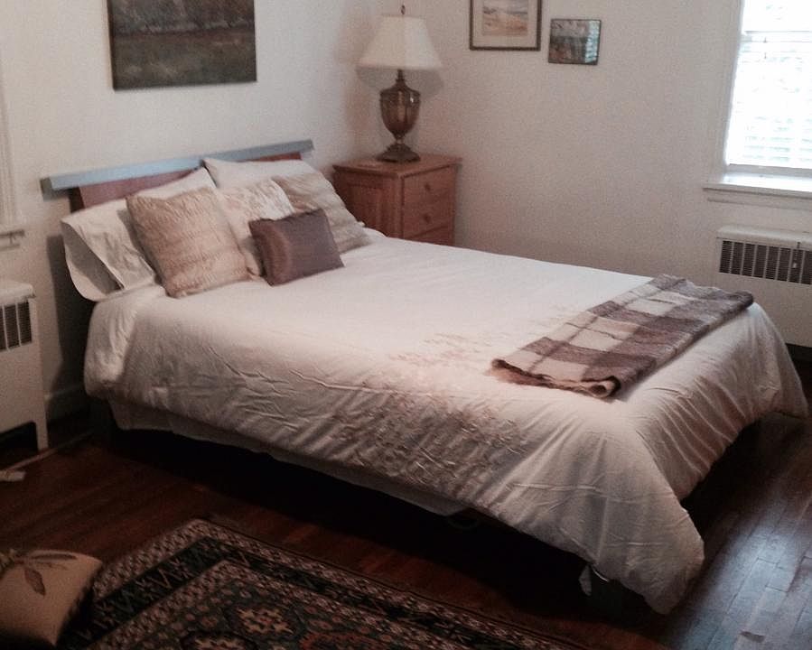 Large master bedroom 18" x 14" with lots of light and hardwood floor.