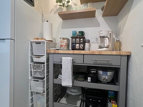 Kitchenette with hot plate, microwave, fridge, dishes, coffee maker, grinder, Keurig, hot water kettle, air fryer, griddle, popcorn maker, salad spinner, rice cooker, toaster, toaster oven