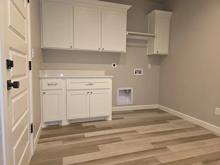 Laundry room with hanging space over the washer/dryer