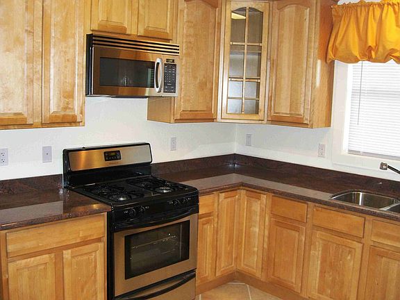 Maple oak cabinets with SS appliances
