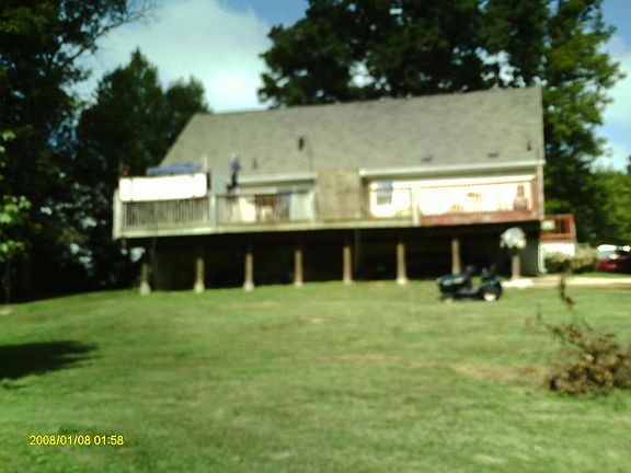 Backyard view, wooded behind this view.
