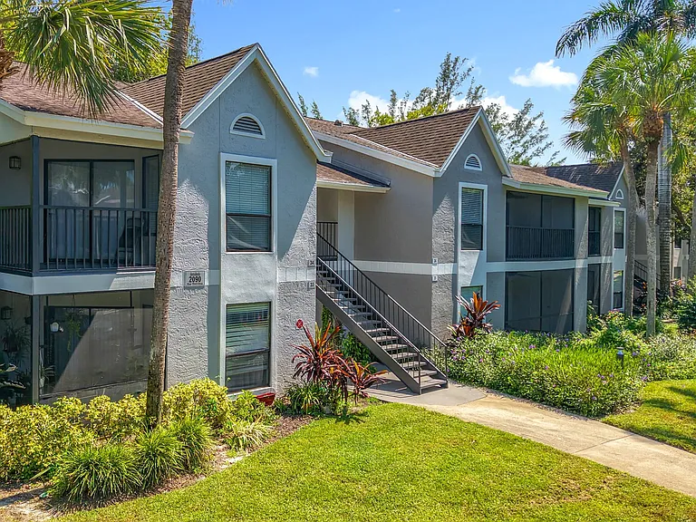 Enjoy morning coffee or evening breezes from your private screened-in patio, surrounded by tropical landscaping and serene green spaces.