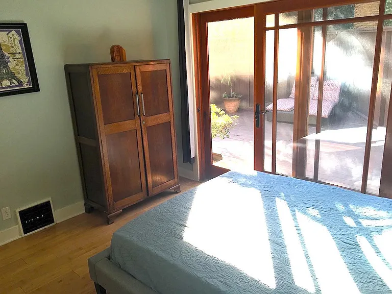 One of two bedrooms that open up to wooden deck