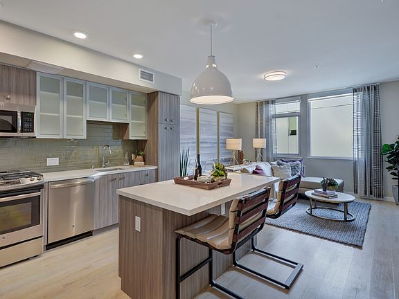 White river colored wood look plank flooring runs through the entire living space