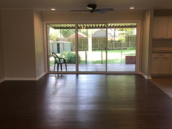 Looking from dining room into living room and out into backyard with new sliding glass door.