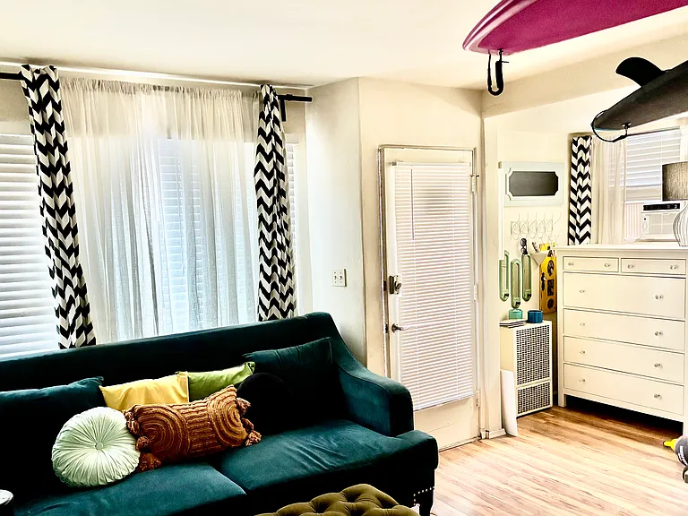 Front door, large windows in living room, office/dresser nook in corner