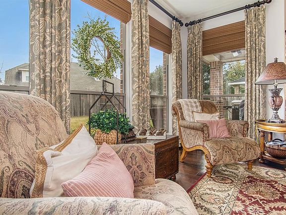 Wonderful large windows with custom blinds and curtains.