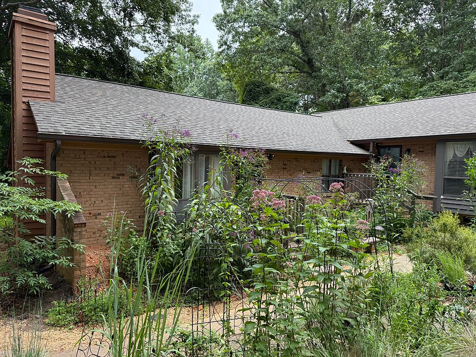 The apartment is this one on the left, behind the wildflowers that grow past the roofline. The living room looks out to a small but very tall pollinator garden.