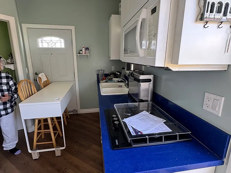 Another view of the kitchen with microwave