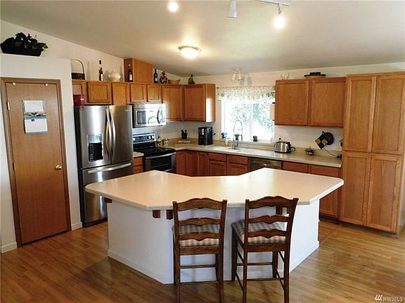 The kitchen has tons of storage, a pantry and an added pantry cupboard, the counters are Corian and the sink is built in for ease of maintaince.  All appliances are included!!!