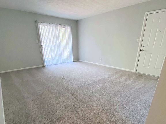 Embrace comfort in our spacious living rooms adorned with plush carpeting and sun-drenched large windows and patio doors with privacy blinds.