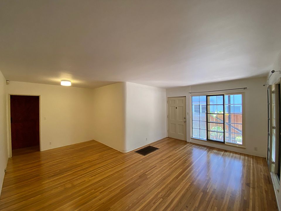 L-shaped living room, with space for dining area or workspace.